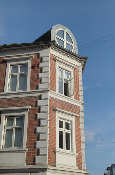 Photo of a red brick building with white details.