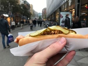 Lille Torv, Aarhus, 4 November 2017 Hand holding hotdog at Lille Torv, Aarhus